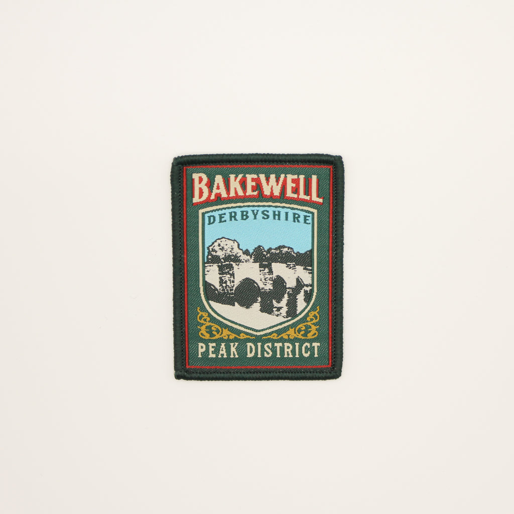 Patch with 'Bakewell Derbyshire Peak District' text and mountain design on a beige background