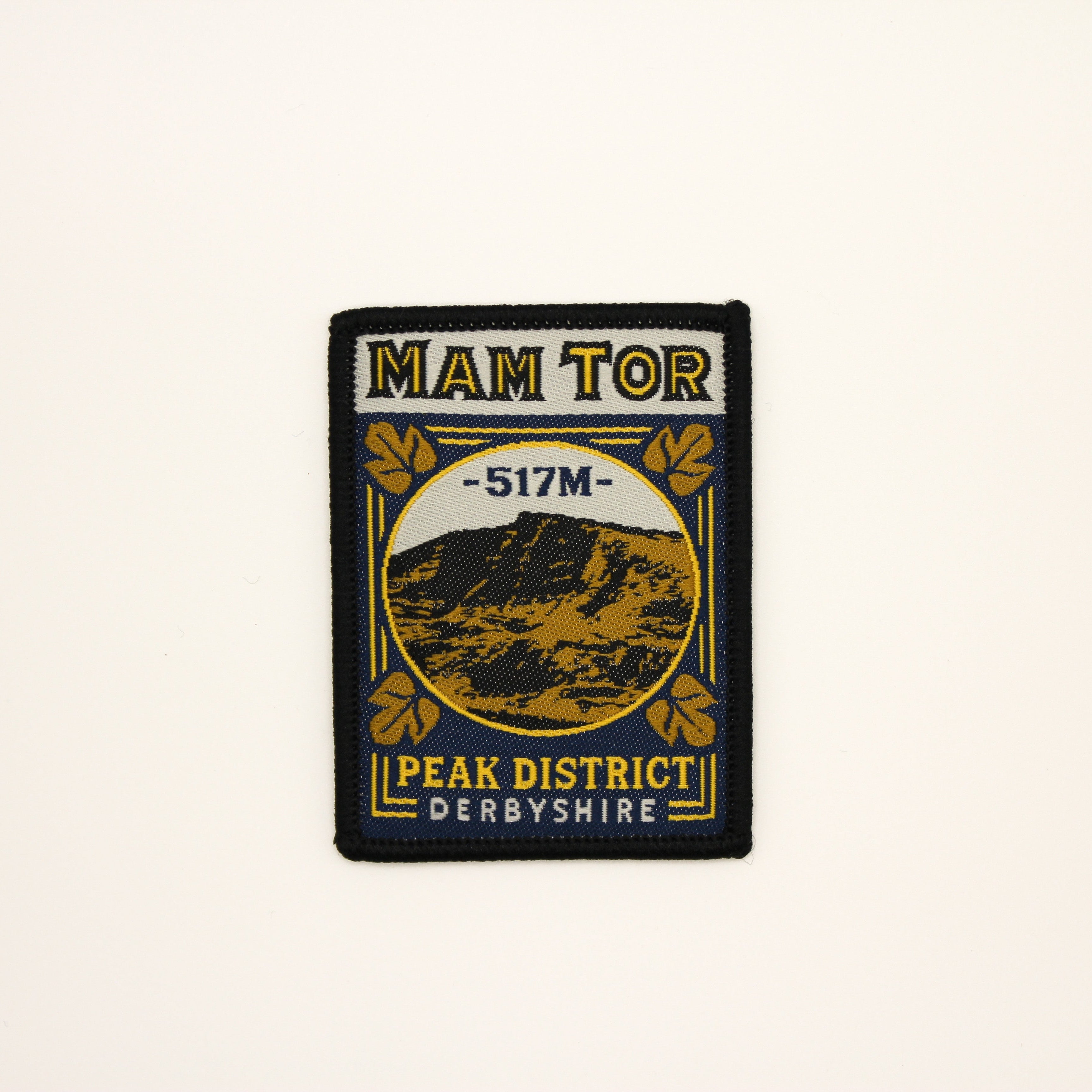 Patch with 'Mam Tor' and mountain illustration on a beige background